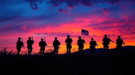 Fototapeta premium Silhouettes of soldiers with the American flag held high, silhouetted against a vibrant sunset.