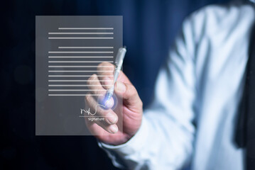 Businessman hand electronic signature on tablet by stylus. Write business agreement of contract....