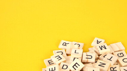 wooden letter cubes on yellow background