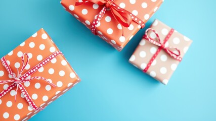 Polka Dot Gift Boxes with Red Ribbon Tied in a Bow on a Blue Background