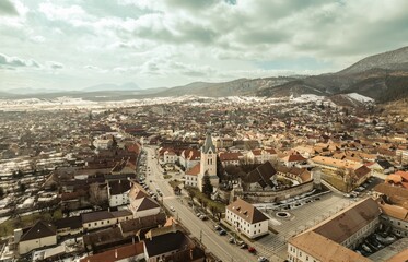 Experience a stunning aerial perspective of Rasnov, nestled at the foot of Piatra Craiului