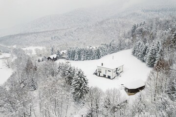 Majestic snow blankets the tranquil landscape of Piatra Craiului, where the charming village of...