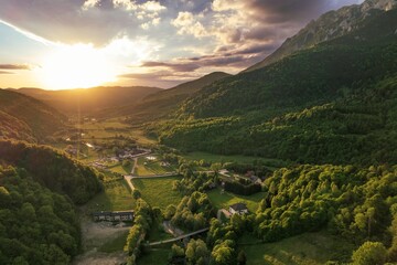 Golden sunlight spills across the lush valleys of Piatra Craiului in Rasnov and Plaiul Foii,...