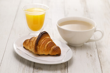 croissant, cafe au lait, and orange juice. French breakfast