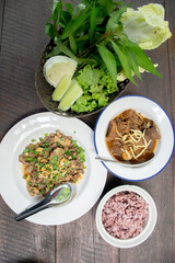 Traditional Thai Meal: Spicy Minced Pork Salad with Herbal Vegetables