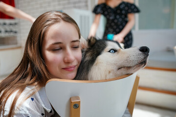 Woman with a Siberian Husky in the snow, enjoying a winter day together