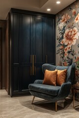 Teal armchair with orange pillows near dark blue closet in a floral-wallpapered room.
