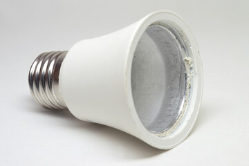 LED bulb housing with aluminum thermal transfer heatsink inside, white plastic coating, shiny metal spiral base