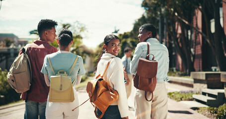 Back, future and walking with student friends outdoor together for learning or study at university. College, education and portrait with happy learner group at school for knowledge or scholarship