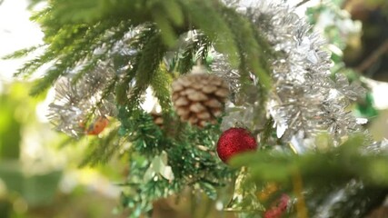 christmas tree decorations background, Forty Wings Christmas Pine Fruit and hanging from above, sparkling ornaments garland close up shot on blurred festive background. selective focus with blur
