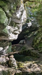 L'entrée de la grotte des Eaux-Chaudes et son gardien de pierre (Béarn)
