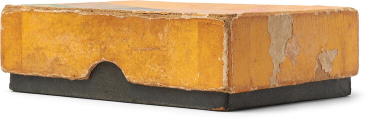 close-up of old and worn out small rectangular cardboard box with yellow lid and black base, faded...