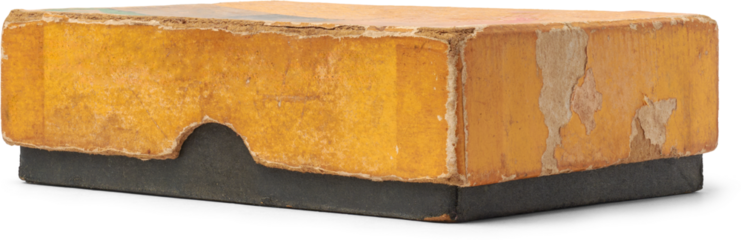 close-up of old and worn out small rectangular cardboard box with yellow lid and black base, faded with uneven discoloration with damage and frayed edges