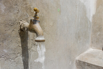 Spout with trough, sink with faucet, pipe and cement sink. Washing, drinking water, open water,...