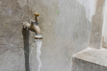 Spout with trough, sink with faucet, pipe and cement sink. Washing, drinking water, open water,...