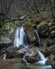 A waterfall flowing through the rocks in the forrest