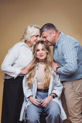 Family bonding moment with parents and their daughter in a cozy indoor setting during a joyful gathering