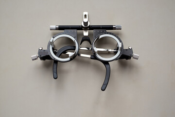 On the table is a frame for adjusting eyeglass lenses. A tool for an ophthalmologist.