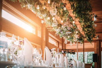 Wooden wedding interior reastaurant decoration with flowers and candles