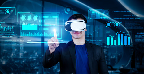 Project manager with VR goggles pointing financial chart and glowing blue light at office. Skilled businessman checking and planning marketing strategy by using data from augmented reality. Ingenuity.