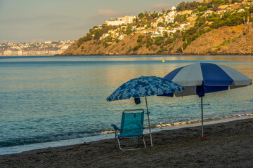 A View to the Opposing Coast on Montril Beach with Umbrellas at Sunrise