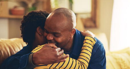 Bonding, hug or love with dad and son on sofa in living room of home together for development. Black family, happy or support with boy child and single parent man embracing in apartment for caring