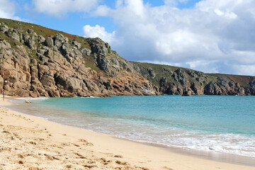 Sandy Porthcurno Beach, with Logan Rock headland, West Cornwall, UK.