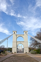 Waco Suspension Bridge tower and cables photographed against a sky with cirrus clouds