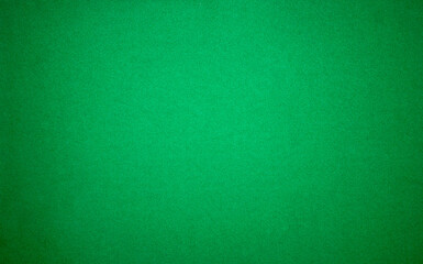 Dark green monochrome background with small dark patches.A photo of the texture of a green felt fabric.