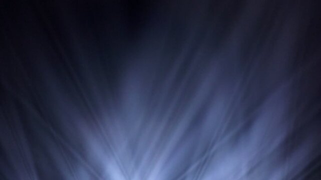 Spot Lights Background Loop. Several bright white stage lights pointing towards the center, of varying sizes. Black and White	