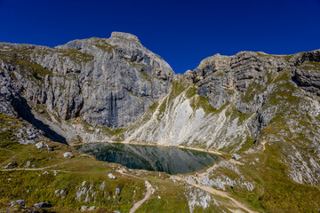 Lake in the Dolomite Alps summer sunny weather landscape. Mountain reflection in the lake in the Dolomiti Alps, South Tyrol, Italy