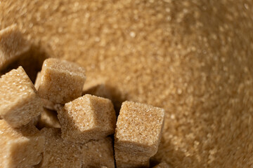 Brown cane unrefined demerara sugar in the form of crystals and cubes