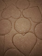 Preparing heart shaped cookies from zucchini and carrot dough for valentine's day