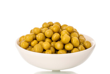 Canned green peas in a white ceramic dish, close-up, isolated on a white background.