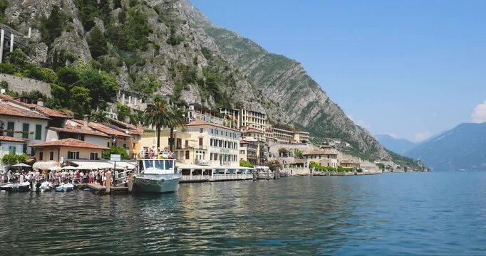 Tourists boarding on a boat at Limone sul Garda in summer in Italy