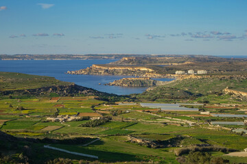 Obraz premium Panoramic View of Maltese Countryside and Coastline Overlooking Golden Bay and Gozo