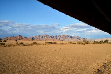 Desert views at dusk during a guided trek in Sossusvlei, Namibia as seen from a vehicle