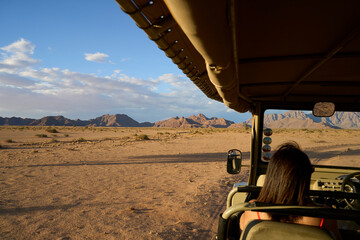 Desert views seen from a moving vehicle at dusk during a guided trek in Sossusvlei, Namibia © Adrian Solumsmo