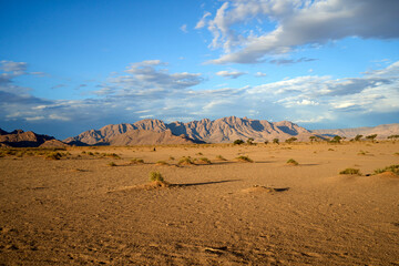 Amazing desert landscape with rocky hills at dusk during a guided trek in Sossusvlei, Namibia