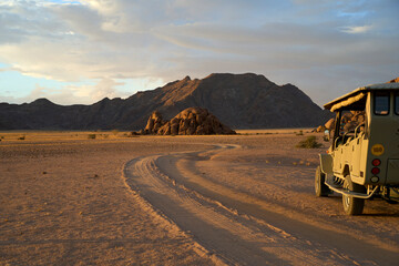 Winding road through the desert at dusk with mountains during a guided trek in Sossusvlei, Namibia