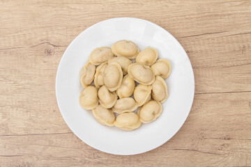 Boiled dumplings in a plate. Top view