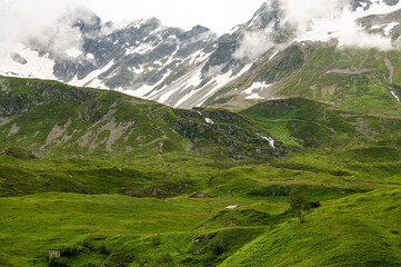 Obraz premium Picturesque panoramic view of the snowy Alps mountains Mont Tondu and Tetes des Bellaval and meadows while hiking Tour du Mont Blanc . Alps, Chamonix-Mont-Blanc region, France, Europe. 