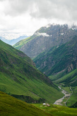 Fototapeta premium LES CHAPIEUX, FRANCE : Mountains chain with lonely farm at the hill side. The region is a stage at the Mont Blanc tour, which crosses three countries. 