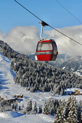 Ski lift over the slopes of Courchevel ski resort by winter