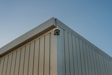 security camera on side of an industrial building