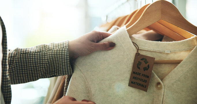 Shopping, store and hands with clothes on rack for recycling, sustainability and eco friendly material. Fashion, boutique and person with tag on textile, clothing and fabric for retail choice