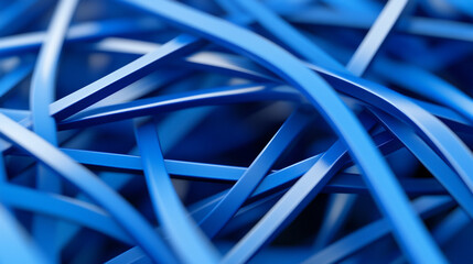 Close-up of intertwined blue rubber bands in a pile creating an abstract design pattern.