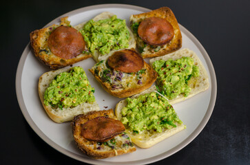 Selection of toasts - avocado toast and pepperoni roll