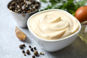 Bowl with mayonnaise and ingredients for cooking on the table