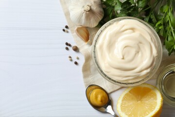 Bowl with mayonnaise and ingredients for cooking on the table